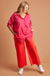 Model Fiona wearing size 16 of the Wide Leg Pant in colour Rust, from the front, showing the whole outfit