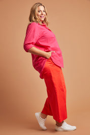 Model Fiona wearing size 16 of the Wide Leg Pant in colour Rust, from the front, showing the whole outfit