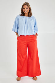 Model Monique wearing size 14 of the Wide Leg Pant in colour Rust, from the front, showing the whole outfit