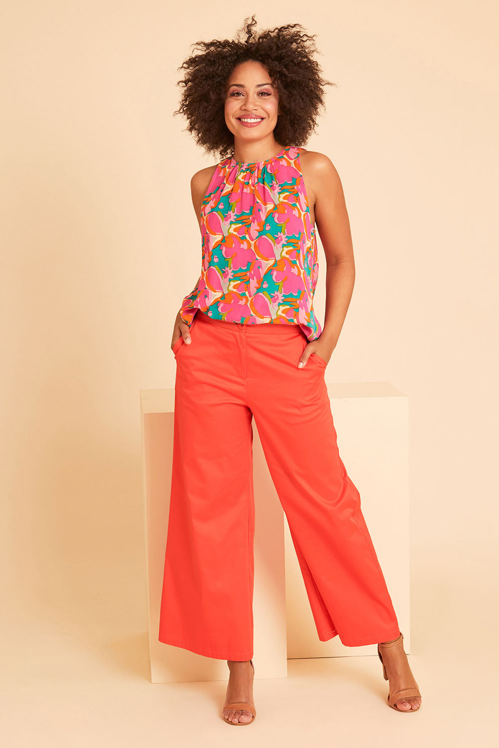 Model Olivia wearing size 10 of the Wide Leg Pant in colour Rust, from the front, showing the whole outfit