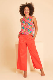 Model Olivia wearing size 10 of the Wide Leg Pant in colour Rust, from the front, showing the whole outfit