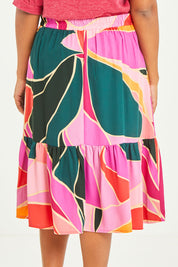 Model Noli wearing size 14 of the Flitter Skirt in colour Geo (Pink), from the back