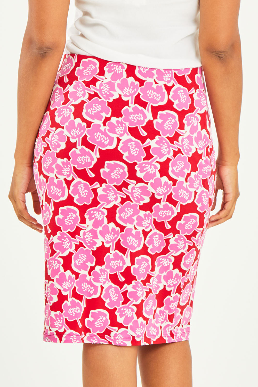 Model Noli wearing size 14 of the Printed Tube Skirt in colour Roses (Red), from the back