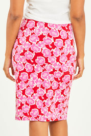 Model Noli wearing size 14 of the Printed Tube Skirt in colour Roses (Red), from the back
