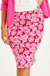 Model Noli wearing size 14 of the Printed Tube Skirt in colour Roses (Red), from the front, cropped image