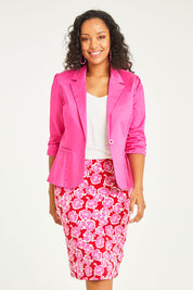 Model Noli wearing size 14 of the Printed Tube Skirt in colour Roses (Red), from the front, cropped image