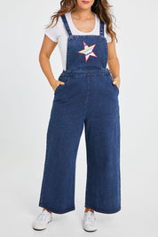 Model Laura wearing size 14 of the Star Overalls in colour Star (Blue), from the front, cropped image