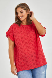 Model Monique wearing size 14 of the Lace Trim Shell Top in colour Lace (Red), from the front, cropped image