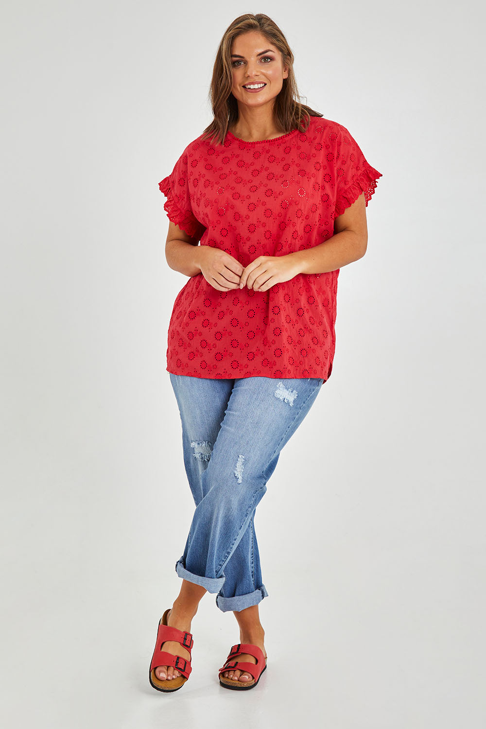 Model Monique wearing size 14 of the Lace Trim Shell Top in colour Lace (Red), from the front, showing the whole outfit