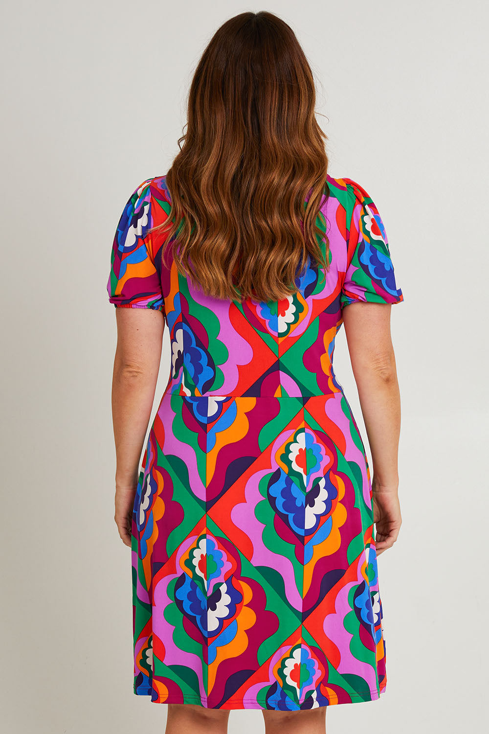 Model Laura wearing size 14 of the Tie Waist Short Sleeve Dress in colour Graphic (Purple), from the back