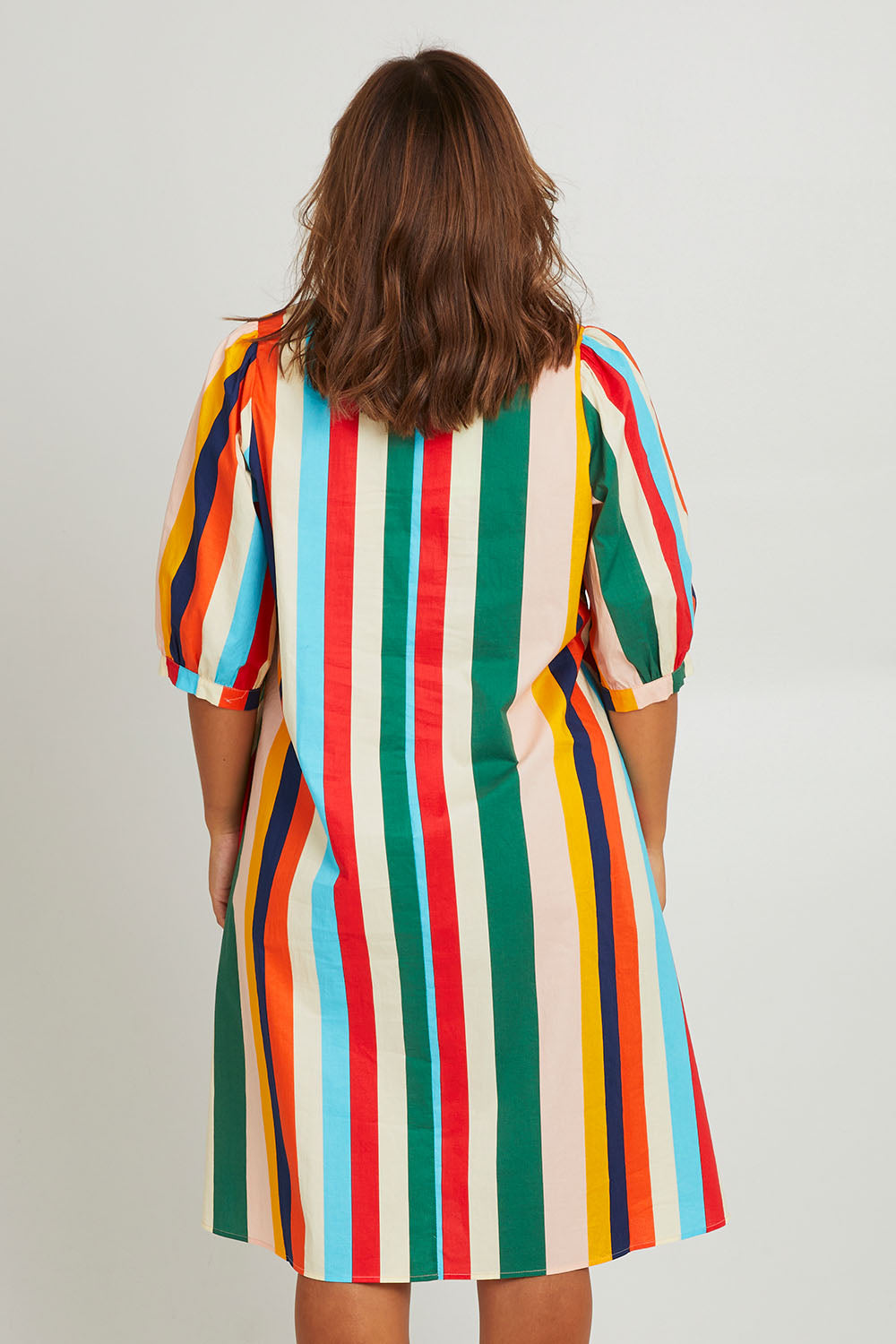 Model Monique wearing size 14 of the V Neck Flounce Sleeve Dress in colour Striped (Blue), from the front, cropped image