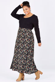 Model Shareefa wearing size 18 of the Printed Maxi Skirt in colour BlackFluer (Black), from the front, showing the whole outfit