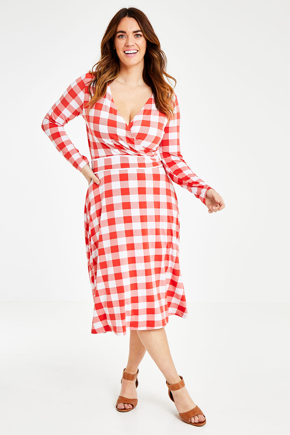 Model Laura wearing size 14 of the Printed Faux Wrap Dress in colour Redcheck (Red), from the front, showing the whole outfit