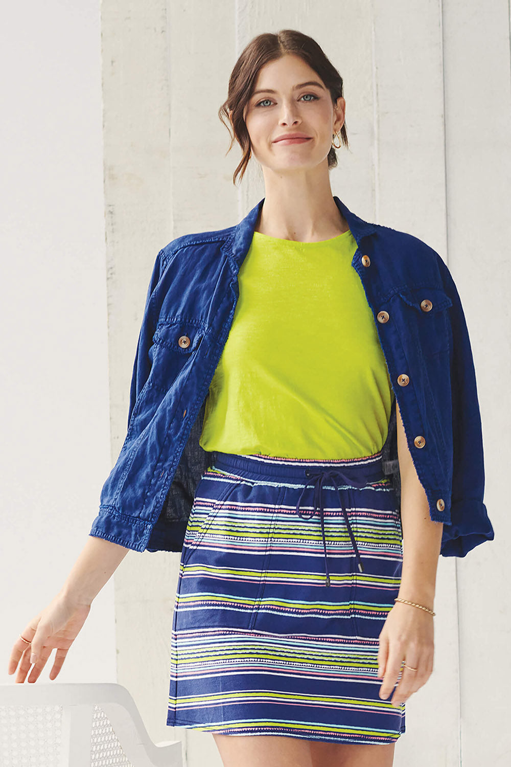 A model wearing the Christine Skirt in colour Stripes (Blue), from the front, showing the whole outfit