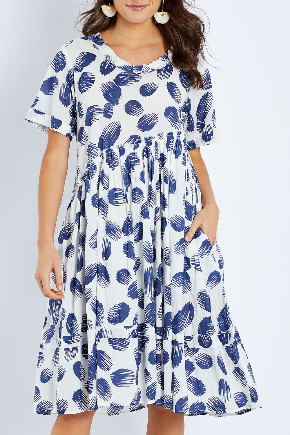 Model Elhana wearing the Aruba Dress in colour Pomelo (Blue), from the front, cropped image