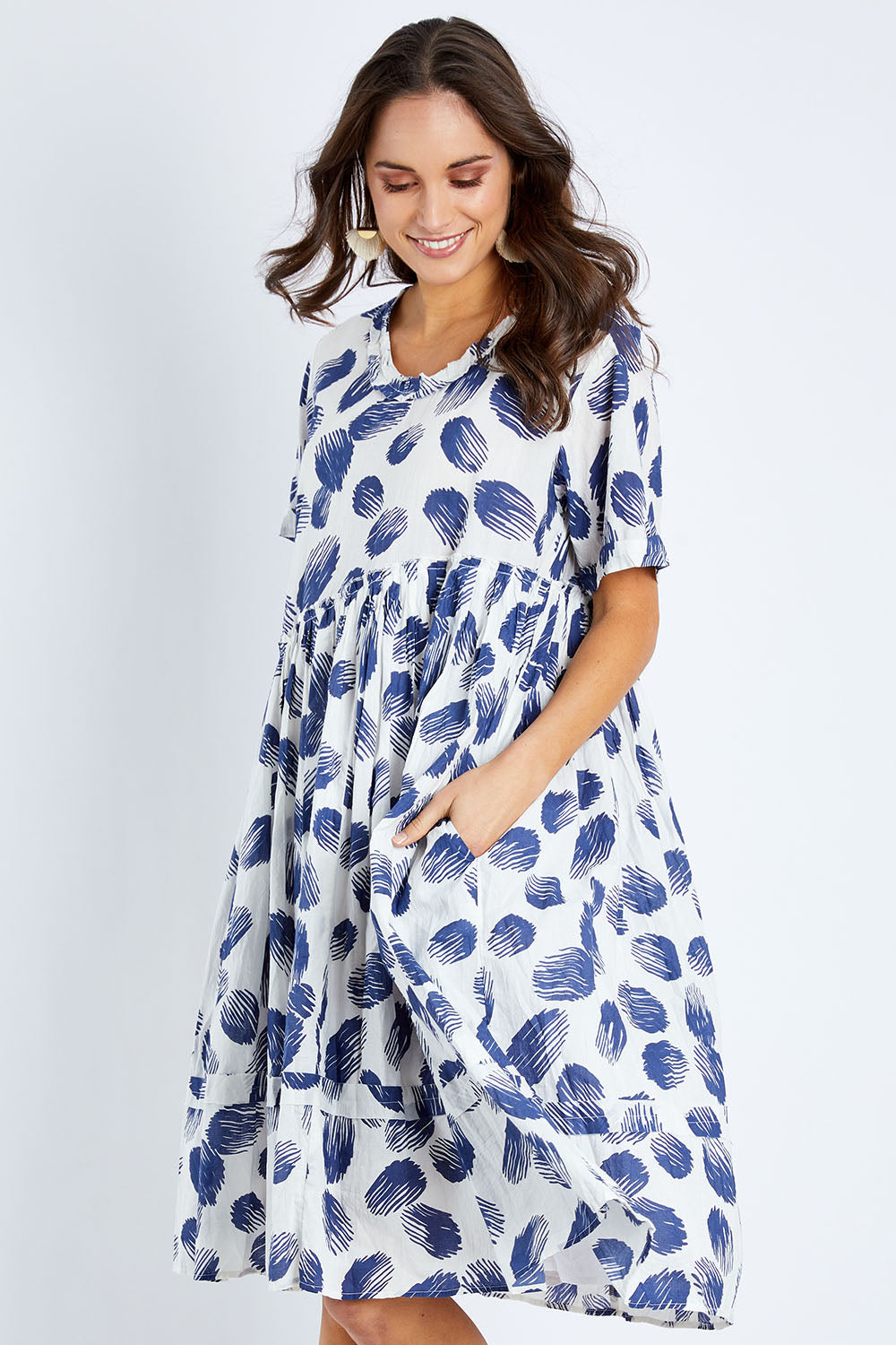 Model Elhana wearing the Aruba Dress in colour Pomelo (Blue), from the front, cropped image