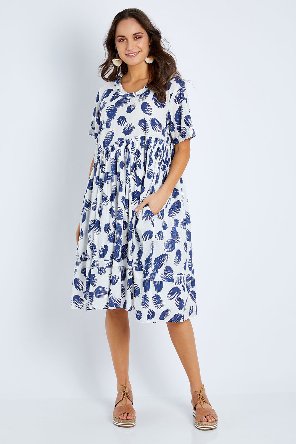 Model Elhana wearing the Aruba Dress in colour Pomelo (Blue), from the front, showing the whole outfit