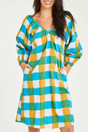 Model Stacey wearing size 10 of the Bloom Dress in colour Checkocean (Blue), from the front, cropped image