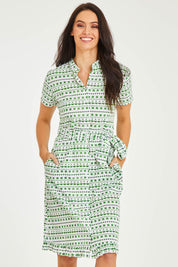 Model Stacey wearing size 10 of the Lizzie Dress in colour Emerald (Green), from the front, cropped image