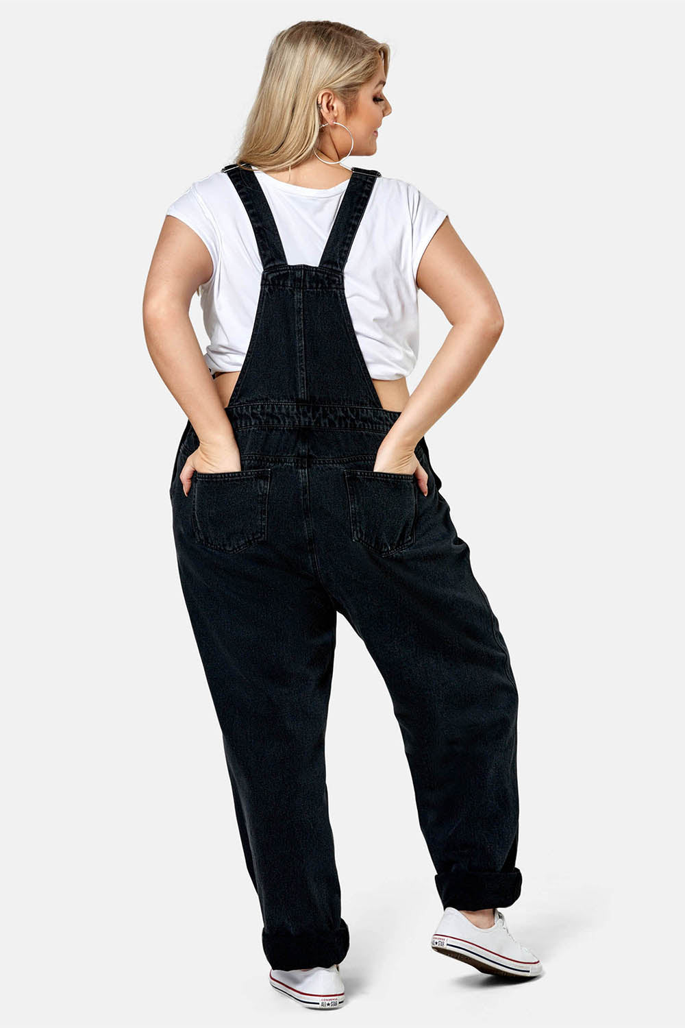 A model wearing the Matilda Overalls in colour Blackwash (Black), from the back