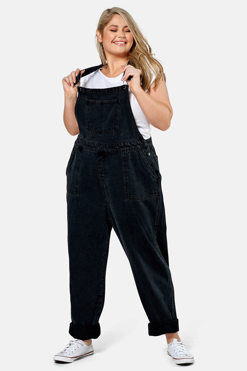 A model wearing the Matilda Overalls in colour Blackwash (Black), from the front, showing the whole outfit