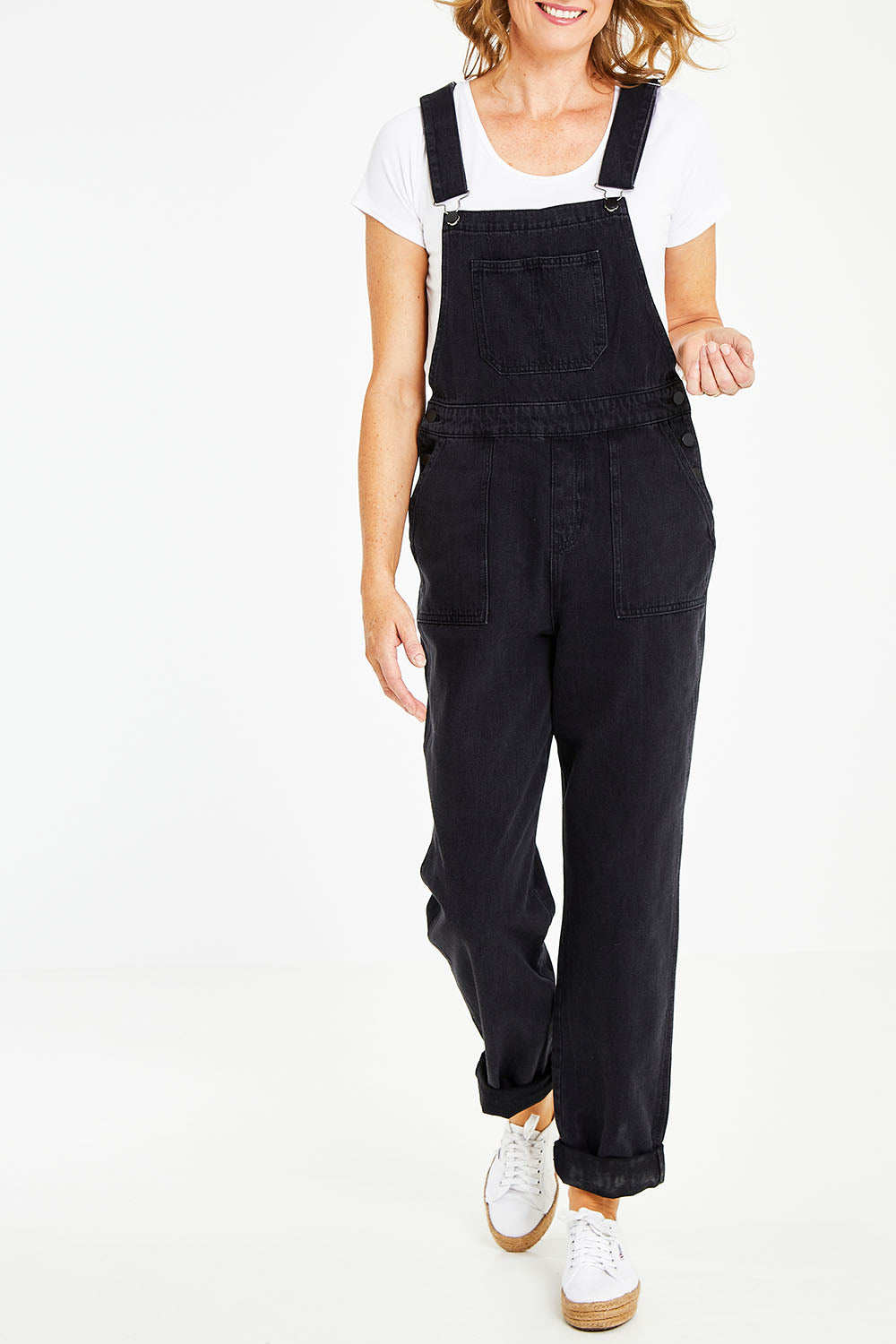 Model Naomi wearing size 10 of the Matilda Overalls in colour Blackwash (Black), from the front, cropped image