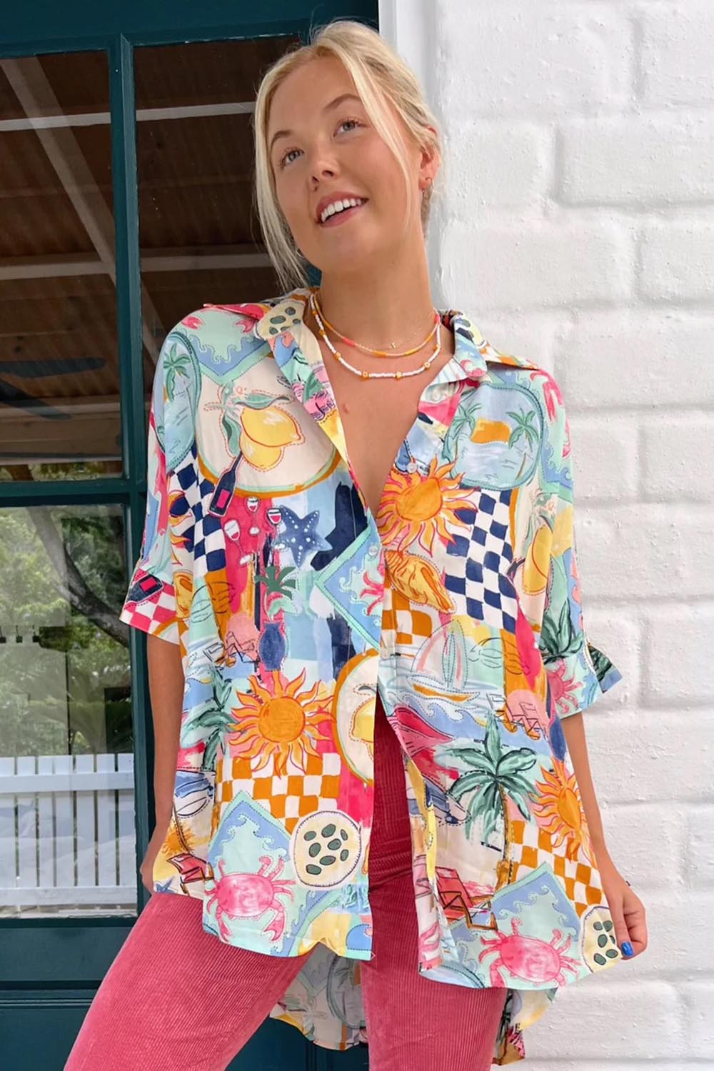 A model wearing the River Shirt in colour Multi (White), from the front, showing the whole outfit