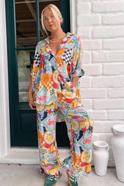 A model wearing the River Shirt in colour Multi (White), from the front, showing the whole outfit