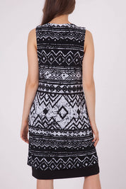 A model wearing the Lexington Panel Detail Dress in colour Prints (Black), from the back
