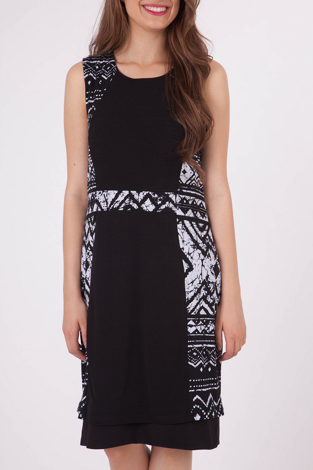 A model wearing the Lexington Panel Detail Dress in colour Prints (Black), from the front, cropped image