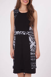 A model wearing the Lexington Panel Detail Dress in colour Prints (Black), from the front, cropped image