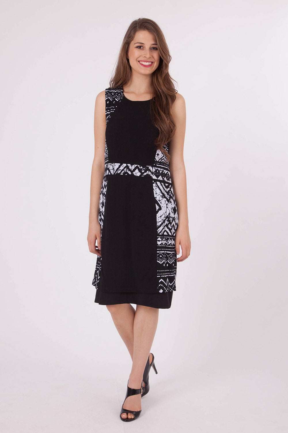 A model wearing the Lexington Panel Detail Dress in colour Prints (Black), from the front, showing the whole outfit