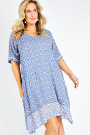 Model Jess wearing size 14 of the Safina Dress in colour Bluedenim (Blue), from the front, cropped image