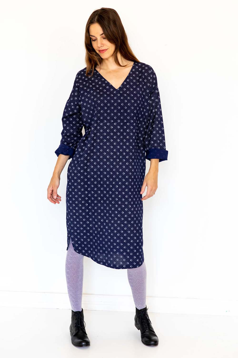 A model wearing the Amelia Dress in colour Elsie (Blue), from the front, showing the whole outfit