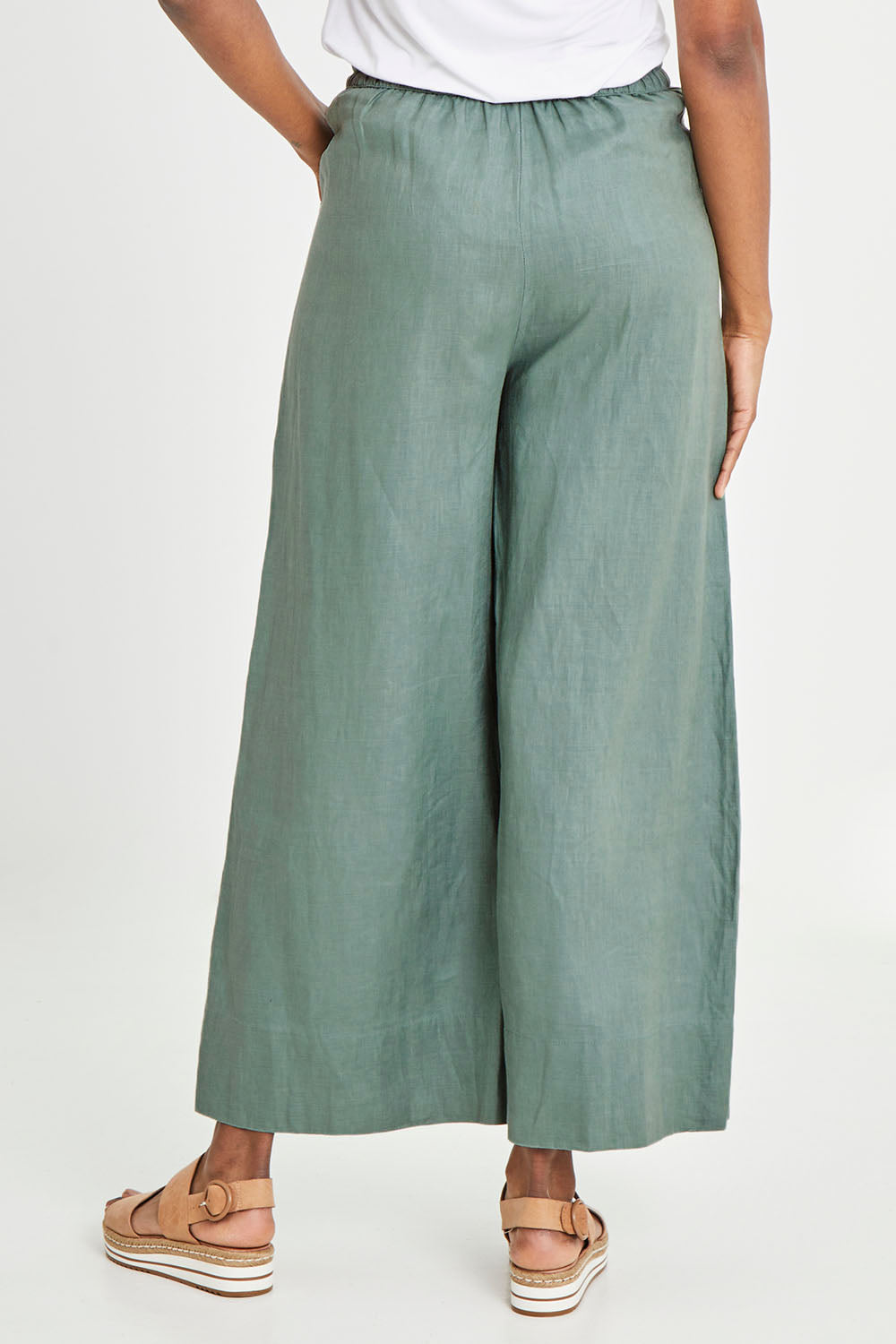 Model Aiyana wearing size S of the Ollie Pant in colour Eucalyptus (Green), from the back