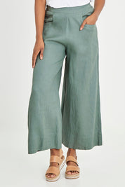 Model Aiyana wearing size S of the Ollie Pant in colour Eucalyptus (Green), from the front, cropped image