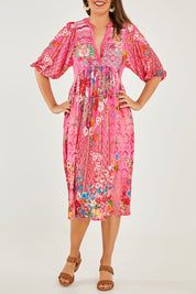 Model Georgia wearing size S of the Frankie Midi Dress in colour Melon (Pink), from the front, cropped image