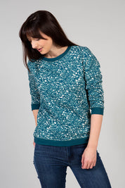 A model wearing the Florrie Crew Neck Sweat in colour Teal (Green), from the front, showing the whole outfit