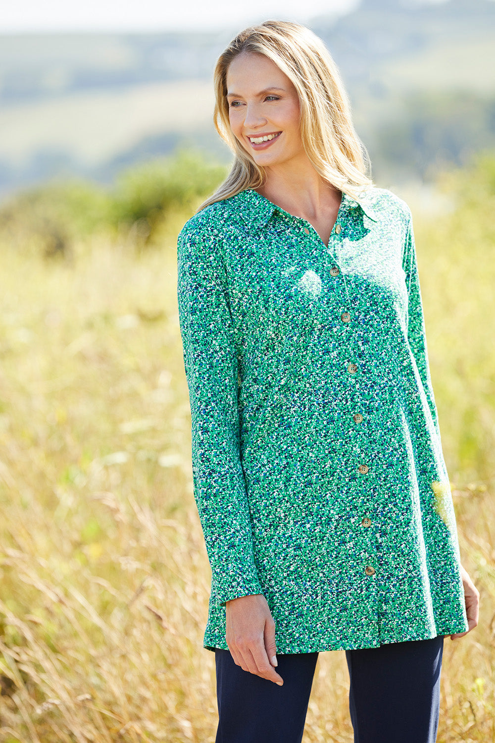 A model wearing the Grange Tunic in colour Bgreen (Green), from the front, showing the whole outfit