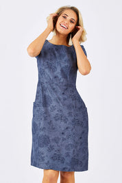 Model Emma wearing size 10 of the Victoria Dress in colour LinearFlor (Blue), from the front, cropped image