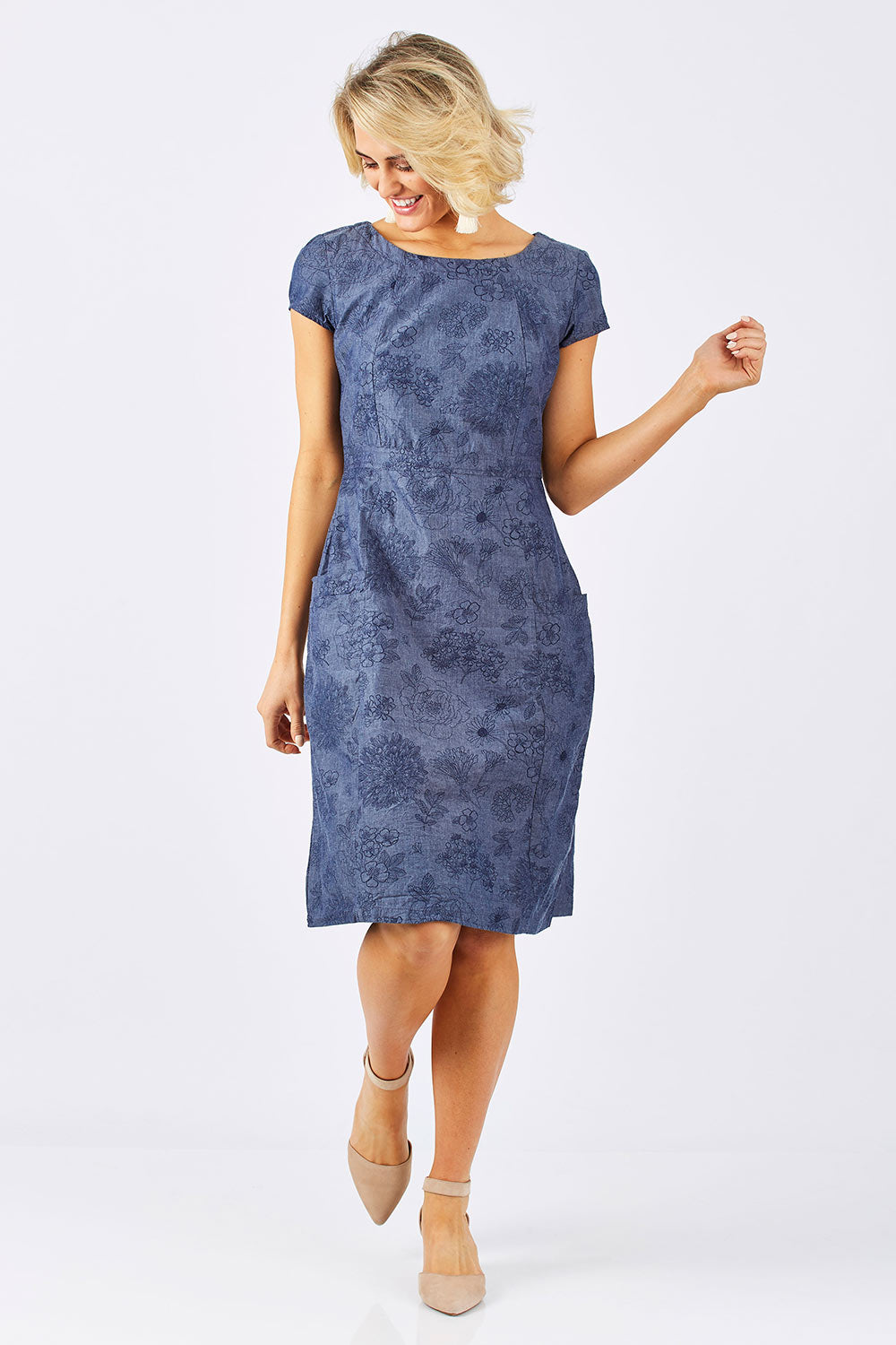 Model Emma wearing size 10 of the Victoria Dress in colour LinearFlor (Blue), from the front, showing the whole outfit