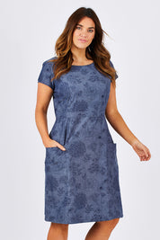 Model Laura wearing size 14 of the Victoria Dress in colour LinearFlor (Blue), from the front, cropped image