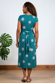 A model wearing the Wrap Midi Dress in colour Darkteal (Green), from the back