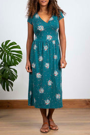 A model wearing the Wrap Midi Dress in colour Darkteal (Green), from the front, cropped image