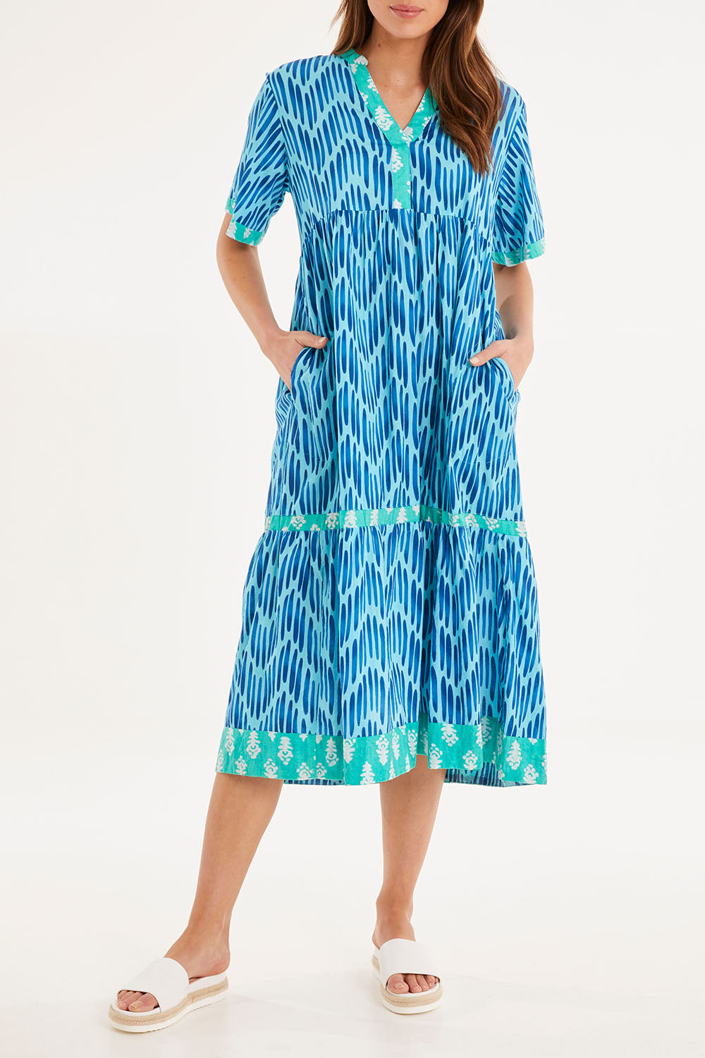 Model Madeline wearing size S of the Chevron Midi Dress in colour Ocean (Blue), from the front, cropped image