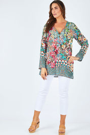 Model Abby wearing size L of the Lindeman Tunic in colour Multi (Pink), from the front, showing the whole outfit