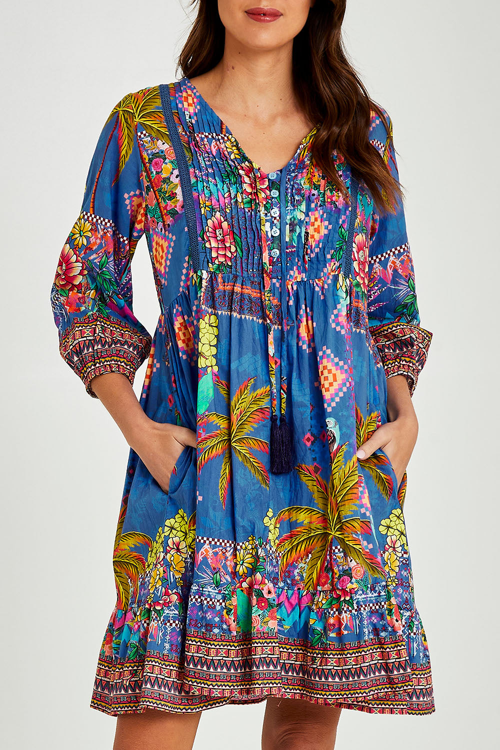 Model Madeline wearing size S of the Mika Dress in colour Ocean (Blue), from the front, cropped image