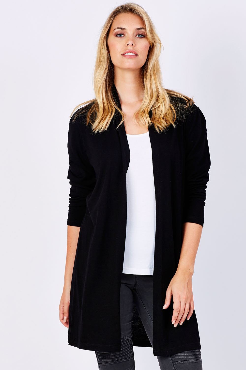 Model Phoebe wearing size 10 of the Merino Long Cardigan in colour Black (Black), from the front, cropped image