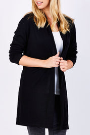 Model Phoebe wearing size 10 of the Merino Long Cardigan in colour Black (Black), from the front, cropped image