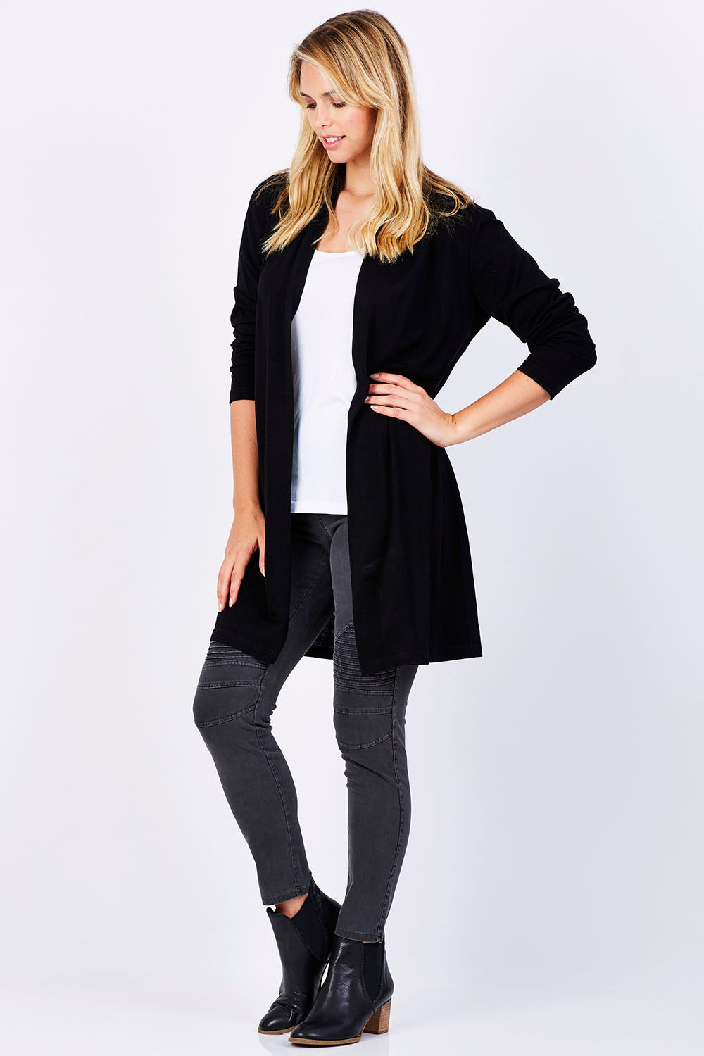 Model Phoebe wearing size 10 of the Merino Long Cardigan in colour Black (Black), from the front, showing the whole outfit